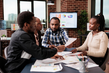 Wall Mural - startup employees doing teamwork to plan project, analyzing information and data on documents. using