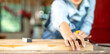 © EKKAPON - Carpenter working on woodworking machines in carpentry shop. woman works in a carpentry shop.