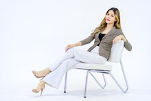 Portrait Isolated Cutout Full Body Studio Shot Millennial Asian Successful Professional Female Businesswoman In Casual Business Suit Sitting On Chair Smiling Look At Camera Posing On White Background.