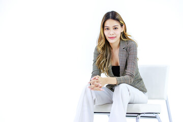 Portrait isolated cutout studio shot Millennial Asian successful professional female businesswoman in casual business suit sitting on chair smiling look at camera posing on white background