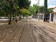 A road covered in thick mud and tracks from scooters and cars after heavy rain and flooding in the capital Dili, Timor Leste, Southeast Asia