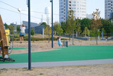 Fototapeta Sport - Children ride a zipline on a playground in the city