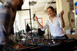 © JustLife - Colleagues having fun at work. Businessman and businesswoman playing table soccer.