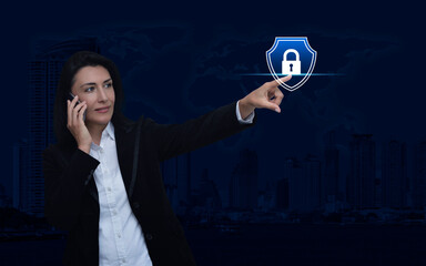 Wall Mural - Businesswoman talking on her cell phone and pointing finger to padlock with shield icon over world map, city tower, Technology security insurance online, Elements of this image furnished by NASA