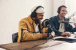 © Jacob Lund - Two college podcasters having a good time in a studio