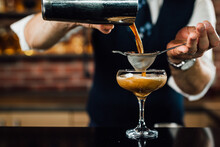 Close Up Of Barman Preparing Espresso Martini Cocktail