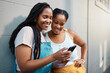 © N Lawrenson/peopleimages.com - Black woman friends with smartphone for social media online check, notification post or reading blog for youth, gen z lifestyle. Teenager girl couple with cellphone typing on chat app, 5g networking