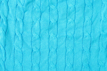 Wall Mural - Blue warm knitted sweater with a pattern. Blue woolen sweater, knitted sweater texture, knitted background. Blue knitted textured background with a pattern closeup