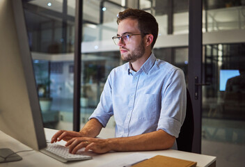 Fototapete - Night worker, businessman and computer planning, working and typing online project proposal, email or trading report. Focus young employee, desktop website and strategy ideas in dark marketing agency