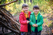 Two Sibling Brothers Boys In The Spring Or Autumn Pine Forest Pl