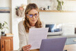 © N Lawrenson/peopleimages.com - Budget, finance and retirement woman with laptop and paperwork for pension savings, bills or income investment on digital bank app. Elderly person with mortgage, financial document or tax management