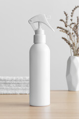 Poster - White cosmetic trigger sprayer bottle mockup with a lavender and towels on the wooden table.