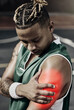 © C Coetzee/peopleimages.com - Fitness, basketball and black man with sports injury in need of first aid or physiotherapy during game. Sportsman from Nigeria with hand on arm, muscle pain and medical emergency on basketball court.