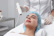 © New Africa - Young woman undergoing face rejuvenation procedure with darsonval in salon