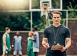 © C Coetzee/peopleimages.com - Basketball coach on court training team for game, tournament and competition outside. Confident, trainer and man focus on workout or teamwork to prepare, motivation and plan play strategy at practice