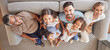 © Alexis Scholtz/peopleimages.com - Happy big family, smile on sofa and top view of generations, grandparents and parents spend time together in living room. Love, diversity and couple with girl kids, grandma and grandpa relax at home.