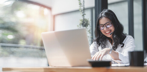 Portrait of  caucasian happy carefree female with eyeglasses having video call via laptop sitting cafe laughing joyfully.