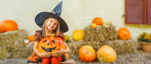 Child Girl Als Little Cute Witch With Pumpkin Outdoors At A Farm Fair