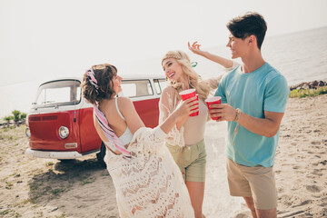 Canvas Print - Photo of three friends alcohol lovers have fun hippie festival concept wear casual outfit nature seaside beach outside