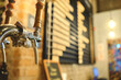 Row of draft beer taps at a bar. Beer taps in a row in perspective. Close up of beer Tap. Selective focus.