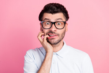 Wall Mural - Closeup photo of young funny attractive handsome cute guy wear lenses bad vision nervous bite nails driving test problems isolated on bright pink color background
