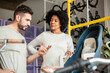 © PhotoAlto - Bicycle store owner talking with African American female customer