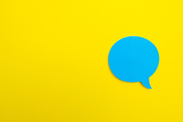 blue empty chat bubble on yellow background