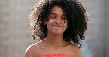 Wall Mural - Happy mixed race preteen girl portrait face close-up