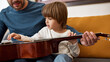 © Svitlana - Partial father teach son play acoustic guitar