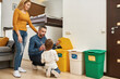 © Svitlana - Mom look at dad teach son throw bottle in dustbin