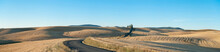 Panoramic View Of The Farmland At Palouse, A Blacktop Road And Undulating Farmland With Stubble Fields.
