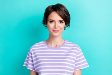 Wall Mural - Photo of positive adorable confident girl with bob hairdo dressed striped t-shirt looking at camera isolated on turquoise color background