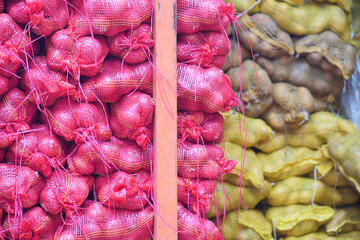 stack of red onion in bags