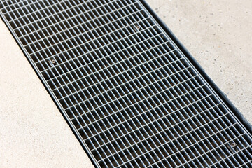 Drain Mesh, Drainage Grate, Drain Floor grille for Rain water on Asphalt Path Background.