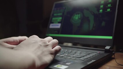 programmer writes program code while sitting at home in front of laptop. Image is focused on screen