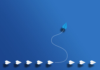 paper planes in a row and one paper glider going in different direction above blue background, break