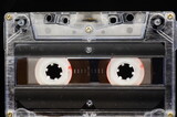 Fototapeta  - Cassette tape - close-up of the whole frame, black background.