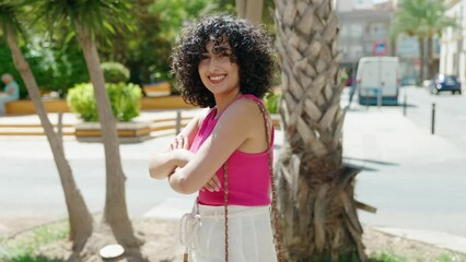 Sticker - Young middle eastern woman standing with arms crossed gesture at street