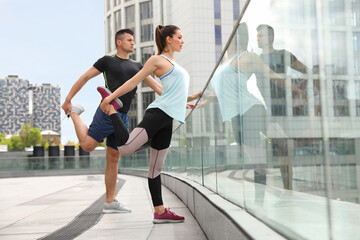 Sticker - Man and woman stretching before morning fitness outdoors