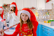 girls in christmas pajamas packing Christmas gifts