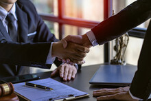Lawyers Closely Shake Hands With Clients On Successful Resolutions Of Cases, Law, Counseling, Agreements, Contracts.