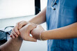 © Lorena - doctor or nurse or sanitary holding hand to patient