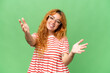 © luismolinero - Young caucasian woman isolated on green screen chroma key background presenting and inviting to come with hand