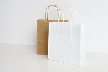  Paper Bags are standing in front of a white wall
