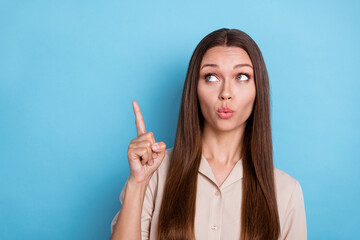 Wall Mural - Portrait of gorgeous nice cute girl with long hairstyle dressed beige shirt indicating empty space isolated on blue color background