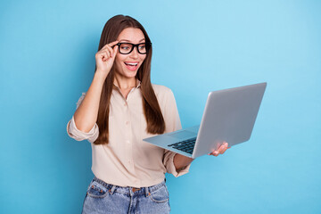 Sticker - Photo of nice cute confident lady straight hairstyle dressed beige shirt hold laptop excited meeting isolated on blue color background