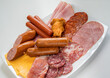 © Tetra Images - Plate filled with unhealthy processed meats and cheese