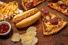 Variety Of Processed Foods With Pizza, Hot Dog, Chips, And French Fries