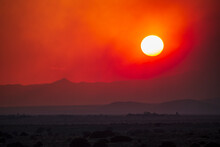 Usa, New Mexico, Santa Fe, Wildfire Smoke And Setting Sun Over Desert Landscape