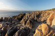 © Tetra Images - South Africa, Gansbaai, Dekelders, Rocky coastline at sunset